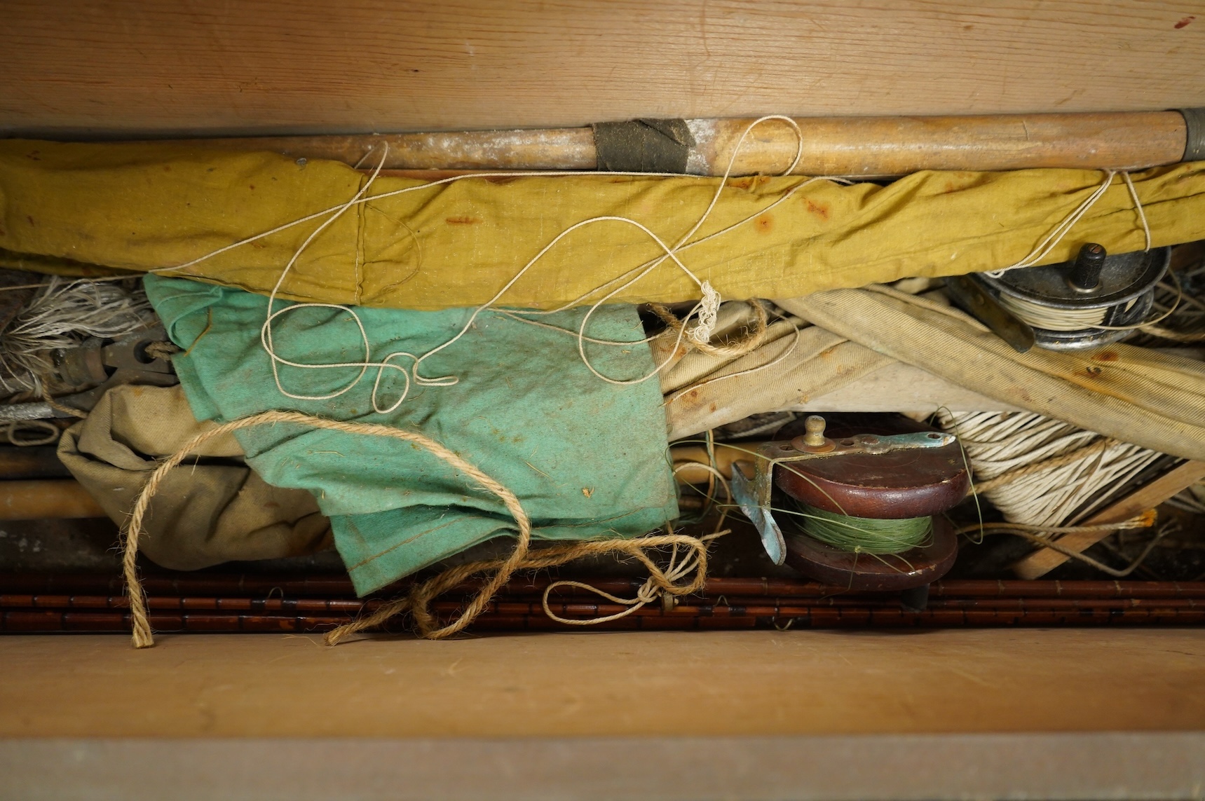 A collection of split cane fishing rods, reels, landing net etc contained in a large wooden box